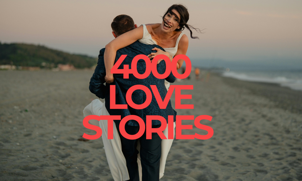 Couple on beach celebrating love stories.